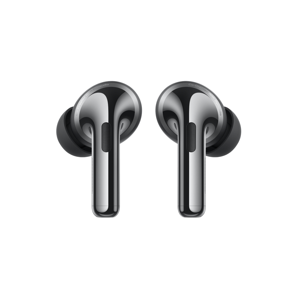 Two modern, sleek black and silver wireless earbuds against a green background.