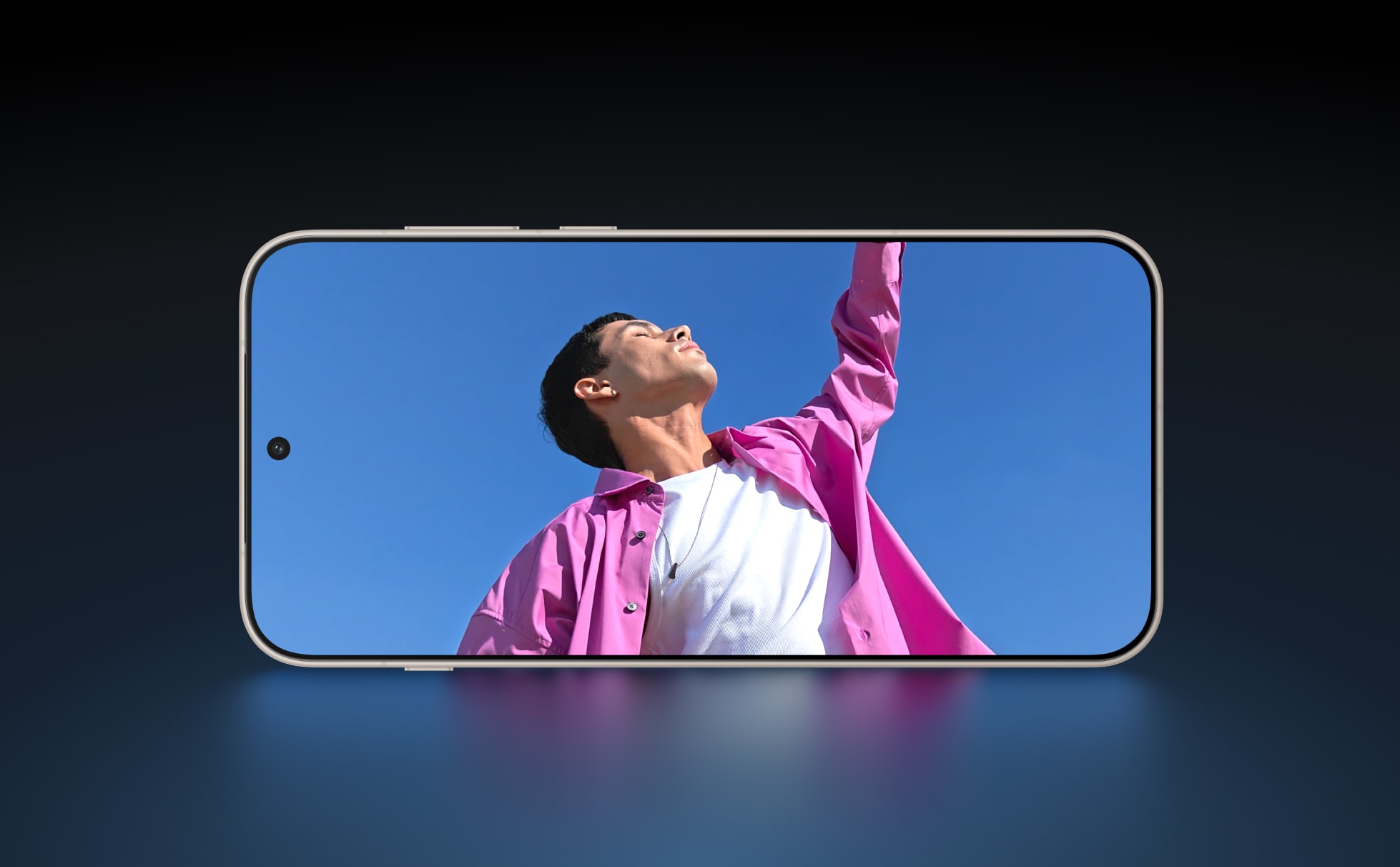 Confident person in pink jacket against blue sky