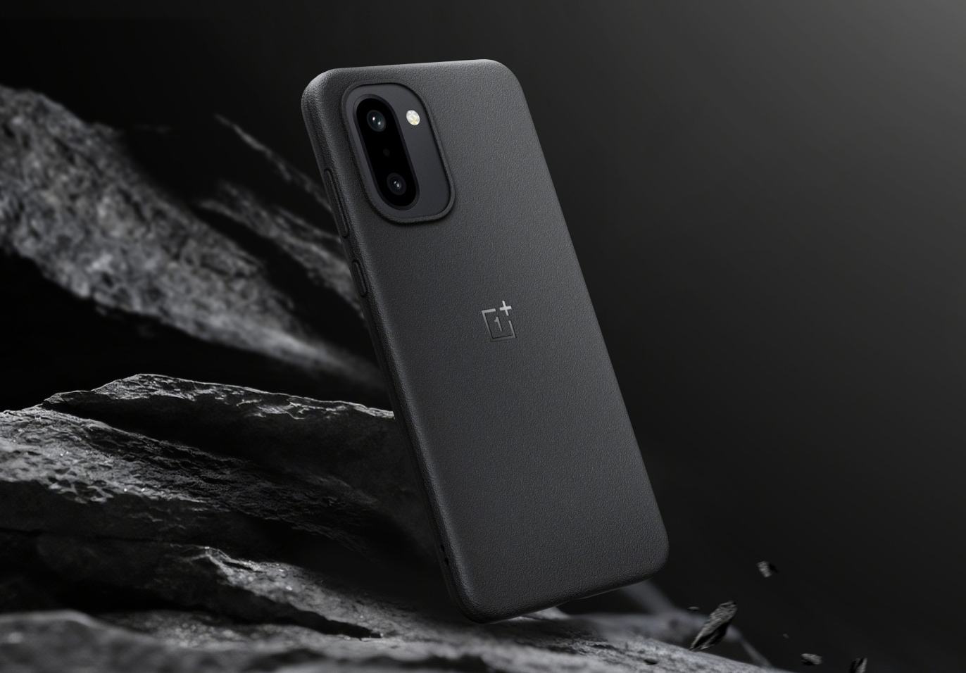 Sleek gray rectangular smartphone with dual camera on rocky background.